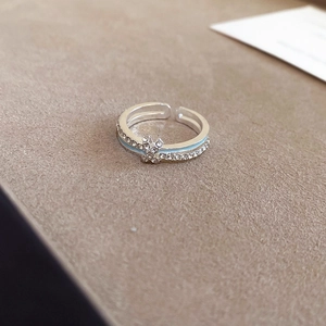 Detailed macro view of silver star ring featuring blue enamel and sparkling zircon pave
