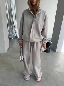 Women's light grey two-piece tracksuit with zip-up sweatshirt and wide-leg joggers