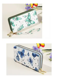 Detail view of double zipper clutch purse with butterfly print and gold hardware