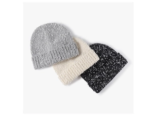 Close-up of thick textured knit hats in charcoal, cream, and black with ribbed edges