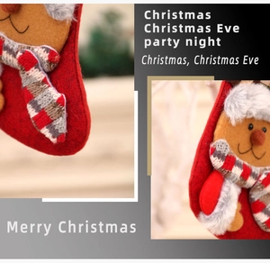 Detail of red felt Christmas stocking with plush reindeer doll and plaid scarf