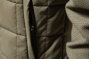 Macro detail of olive green quilted jacket featuring invisible zipper pocket and mesh texture