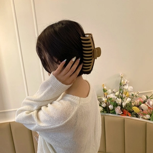 Elegant oversized matte brown hair claw clip for women shown on model hair