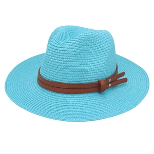 Detail of blue straw fedora with fine weaving and brown leather strap with metal studs