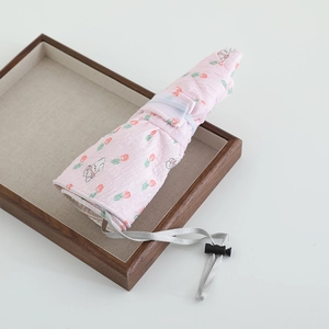 Close-up of pink sun hat with cute rabbit print and adjustable drawstring in detail view