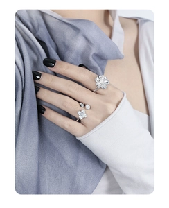 Close-up of S925 sterling silver rings with zircon flowers and pearl accents