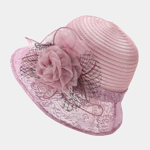 Detail of pink organza sun hat with large floral decoration and black mesh veil