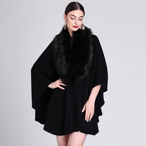 Elegant black knit poncho with faux fox fur collar for women in a stylish mid-length design