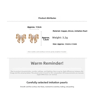 Detailed size view of golden bow earrings with zircon and pearls measuring 1.5cm by 1.5cm