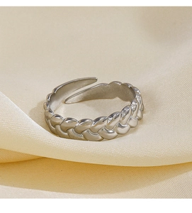 Detail of twisted cable texture and adjustable open band on silver stainless steel ring