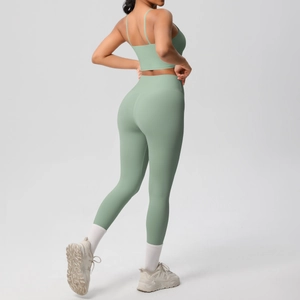 Sage green yoga set featuring thin strap sports bra and high waisted leggings back view