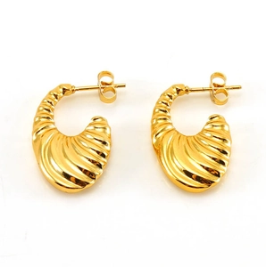 Detailed close-up of golden croissant-style earrings with ripple texture and vintage finish