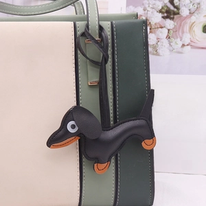 Beige and olive green tote bag featuring a cute black leather dachshund puppy pendant