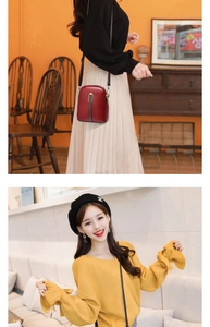 Red PU leather crossbody bag with metal buckle and stripe detail shown on a model