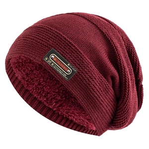 Detail view of burgundy knitted beanie showing warm fleece lining and classic leather patch