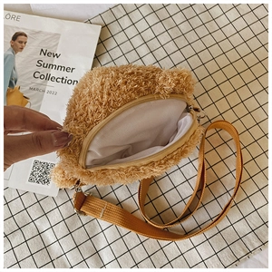 Close-up of brown plush teddy bear bag interior with white lining and zipper detail