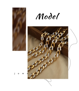 Macro detail of gold-plated Cuban chain necklace featuring sparkling pave diamond links