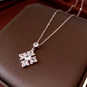 Exquisite silver flower zircon pendant necklace displayed on luxury jewelry box and silk