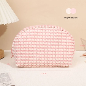 Detailed view of checkered plush makeup bag with circular zipper and dimensions