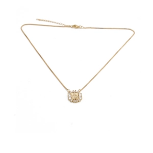 Golden necklace with rectangular zircon-encrusted pendant and carved relief on white base