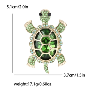 Green crystal turtle brooch in gold metal with size dimensions 5.1cm by 3.7cm