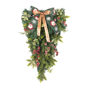 Decorazione natalizia a goccia con aghi di pino, bacche rosse e fiocco di Babbo Natale