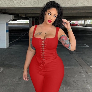 Detail view of the red ribbed two-piece set featuring front lace-up top and slim fit pants