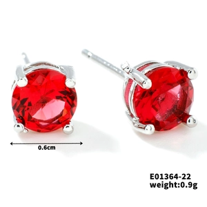 Detail view of 6mm red crystal stud earrings with classic silver four-prong setting