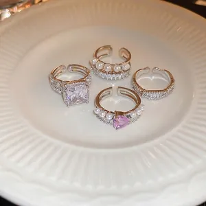 Ensemble de bagues en perles et zircons avec cristal cœur et carré sur céramique