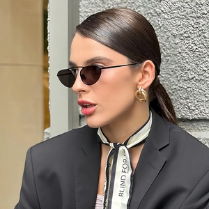 Fashionable gold twist earrings for women, minimalist metal knot style on female model