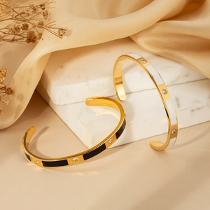 Elegant gold-plated C-shaped stainless steel bangles with black and white inlay details