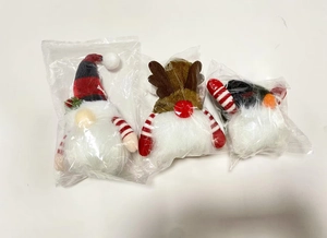 Three-piece Christmas plush gnome and elk doll set inside clear plastic packaging