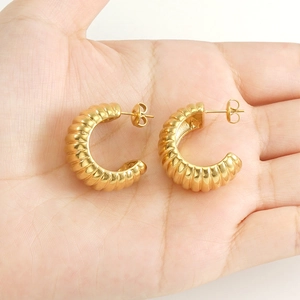 Classic 18k gold plated stainless steel croissant dome hoop earrings on palm
