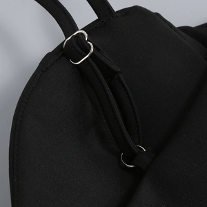Detail of adjustable black strap with silver metal slider on a sleek women garment