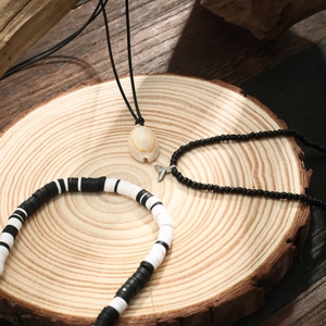 Bohemian shell fish tail beaded necklace and bracelet set on rustic wooden tray