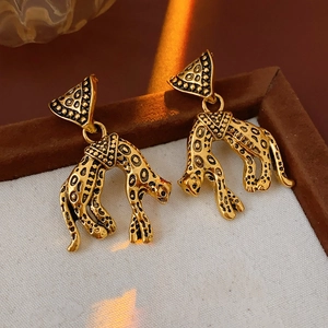 Detailed view of vintage gold leopard head earrings with textured antique finish