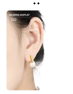 Wearing display of French vintage twist hoop earrings with elegant inlaid pearls
