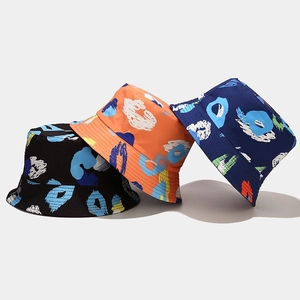 Close-up of bucket hats with abstract graffiti prints in black, orange and navy blue