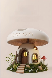 Detailed close-up of a resin mushroom house ornament with warm light and stone details
