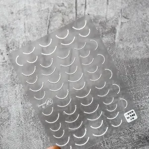 Detailed macro view of 5D embossed pearl nail stickers with adhesive backing on stone texture