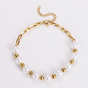 Detailed close-up of a gold link chain and pearl bracelet with adjustable lobster clasp