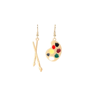 Detailed view of creative asymmetric gold earrings featuring a paintbrush and palette design