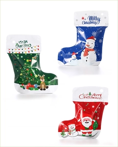 Detailed view of stocking-shaped Christmas gift bags in red, blue and green colors