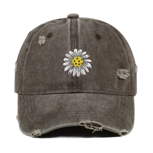 Detailed view of vintage distressed baseball cap featuring a daisy soccer ball embroidery