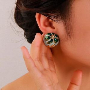 18K gold plated oval earrings with enamel flower pattern and zircon inlay on model