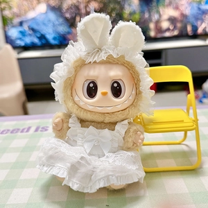 Close-up of Labubu plush doll wearing white lace dress and bunny ears on yellow chair