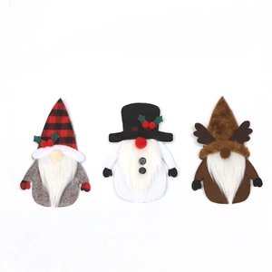 Three Christmas gnome cutlery holders with reindeer antlers and plaid hats on white base