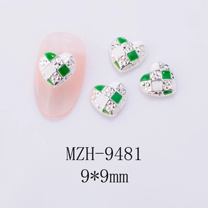 Macro detail of Y2K heart checkerboard nail charm with green enamel and tiny zircons