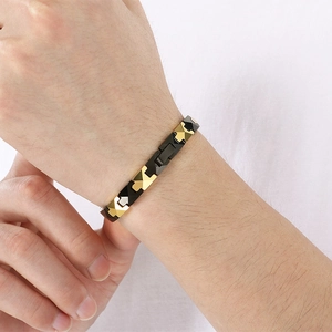 Detailed close-up of a men's tungsten steel bracelet with gold and black geometric links