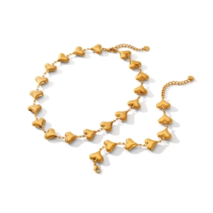 Polished 18K gold heart link chain necklace with lobster clasp on a white background